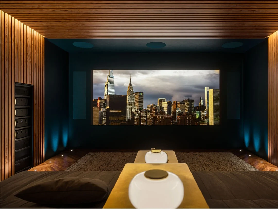 Dark, cinematic home theater with large screen and immersive seating