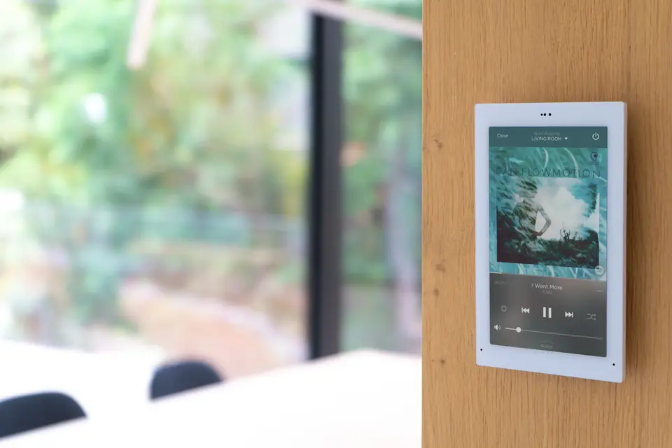 Person controlling multi-room audio from a tablet